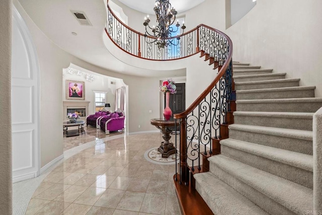 foyer with a towering ceiling and a chandelier