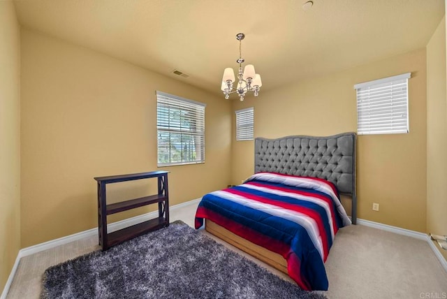 bedroom featuring a notable chandelier and carpet flooring