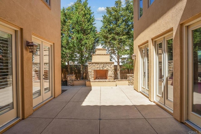 view of patio featuring an outdoor stone fireplace