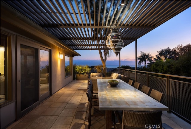 patio terrace at dusk featuring a pergola