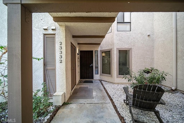 doorway to property with a patio area