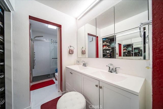 bathroom with vanity, toilet, an enclosed shower, and tile patterned flooring