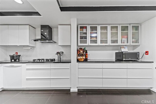 kitchen with white cabinetry, dishwasher, wall chimney range hood, and stainless steel gas cooktop