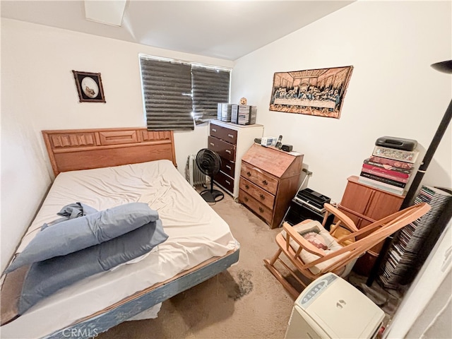 carpeted bedroom featuring lofted ceiling