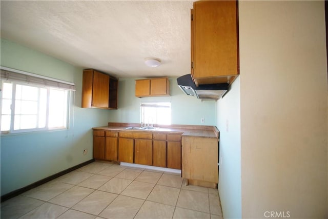 kitchen with light tile patterned flooring and sink