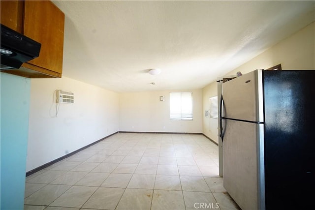 kitchen with light tile patterned flooring and stainless steel refrigerator