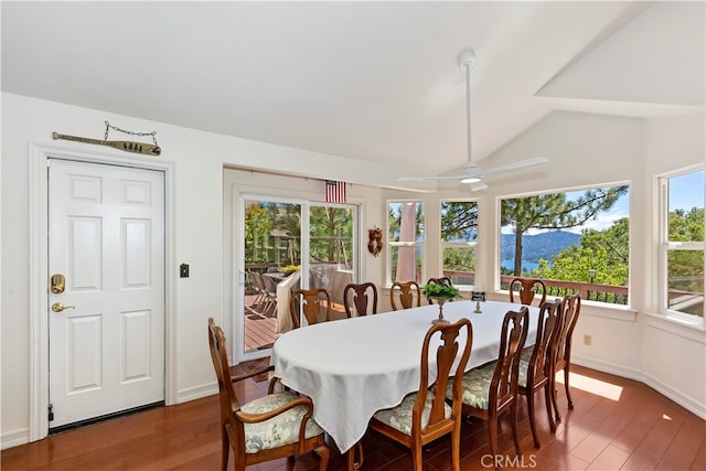 dining space featuring a wealth of natural light, vaulted ceiling, dark hardwood / wood-style floors, and ceiling fan