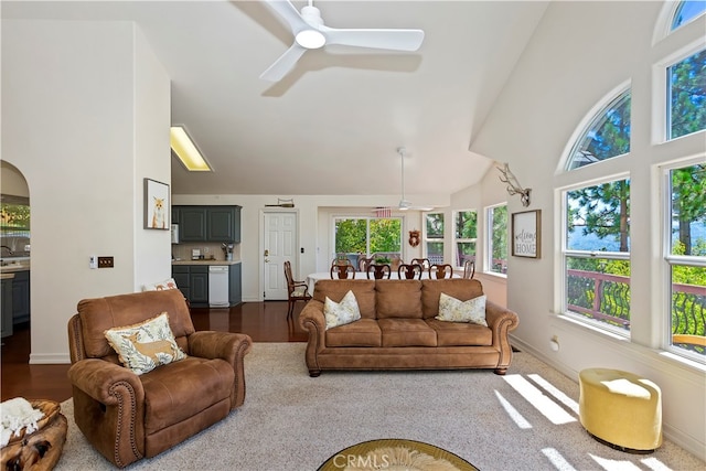 living room with high vaulted ceiling, wood-type flooring, and ceiling fan