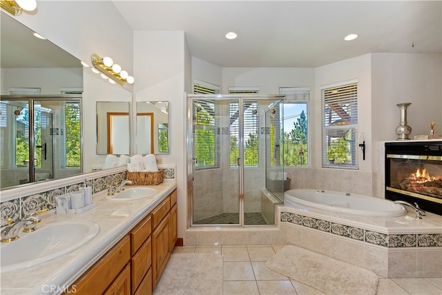 bathroom featuring vanity, independent shower and bath, and tile patterned flooring