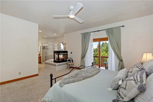 bedroom with light carpet, access to outside, ensuite bath, and ceiling fan