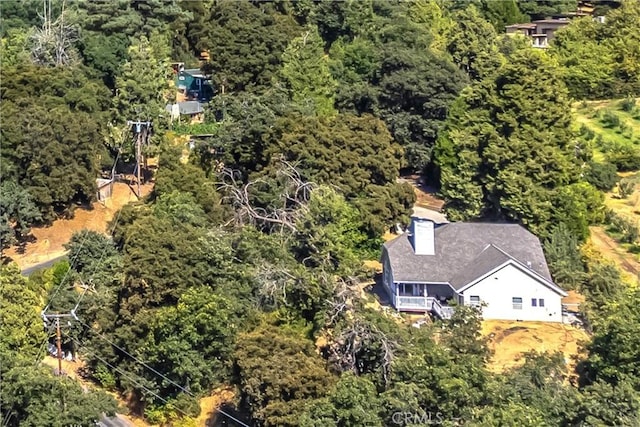 bird's eye view featuring a wooded view