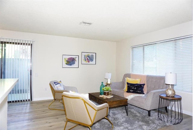 living room featuring a wealth of natural light and hardwood / wood-style flooring