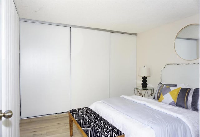 bedroom featuring light hardwood / wood-style floors and a closet