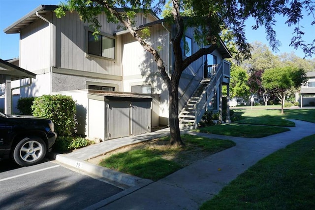 view of side of property with a yard