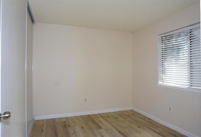 spare room with light hardwood / wood-style flooring