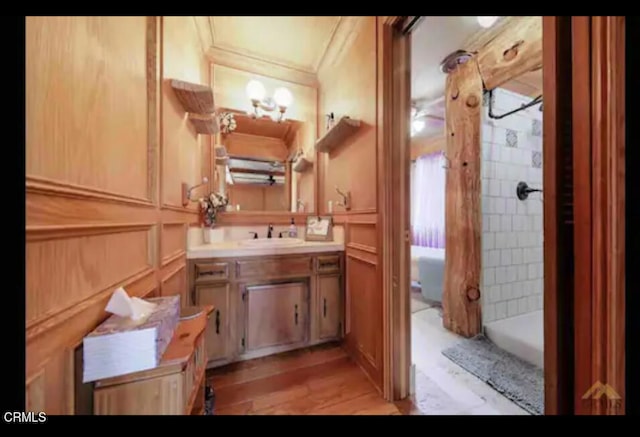 bathroom featuring vanity, crown molding, and hardwood / wood-style floors