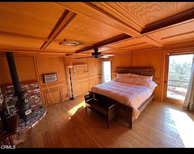 bedroom with beamed ceiling, light hardwood / wood-style flooring, a wall mounted air conditioner, and wooden ceiling