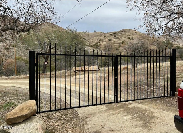 view of gate with a mountain view