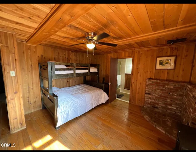 bedroom with wood ceiling, wood walls, beam ceiling, and light hardwood / wood-style flooring