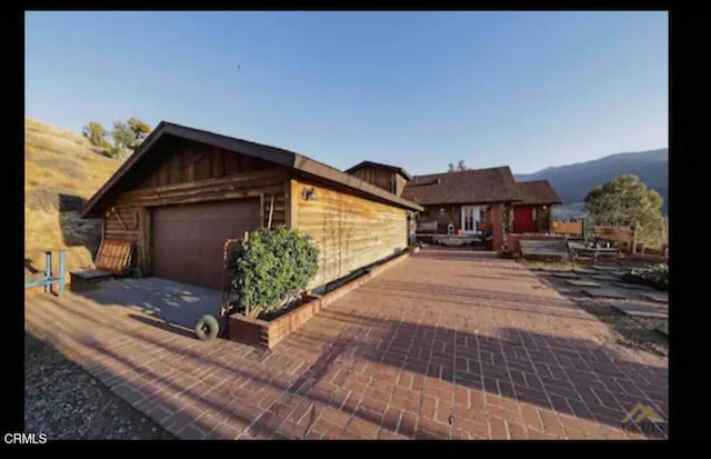 view of front of house with a mountain view and a garage