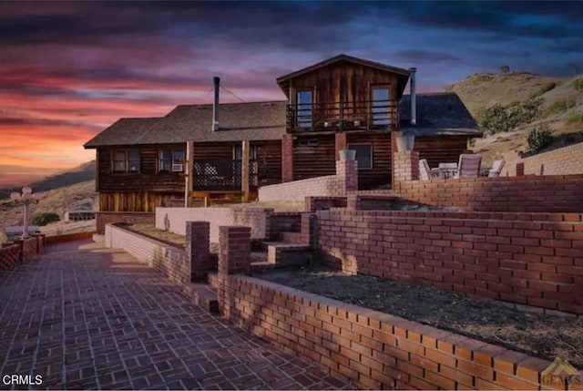 cabin featuring a patio area and a balcony