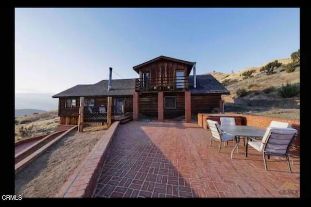 rear view of house featuring a deck with mountain view