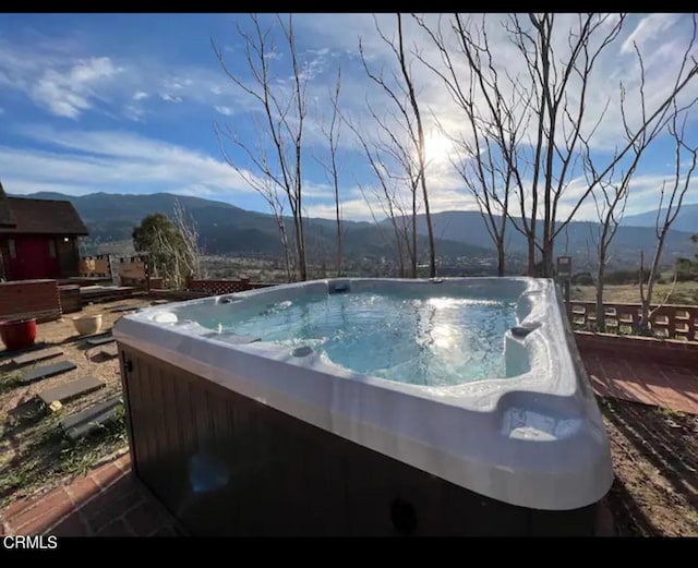 view of pool featuring a mountain view and a hot tub