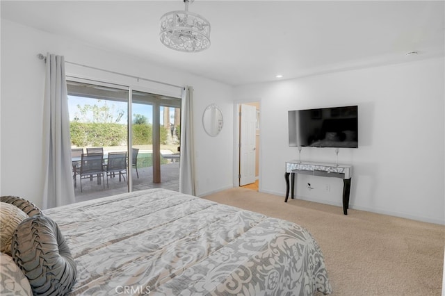 carpeted bedroom with an inviting chandelier and access to exterior