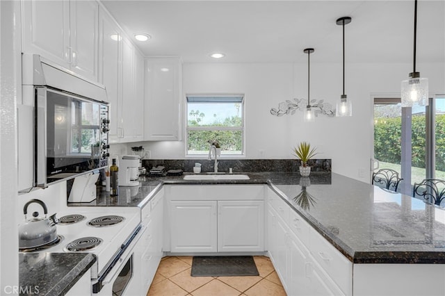 kitchen featuring hanging light fixtures, light tile patterned flooring, white cabinets, white electric range, and sink