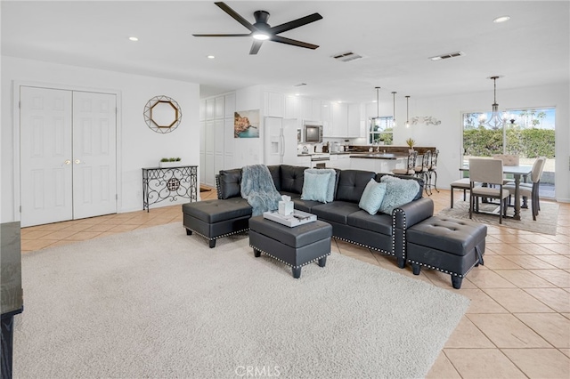 living room with ceiling fan, sink, and light tile patterned floors