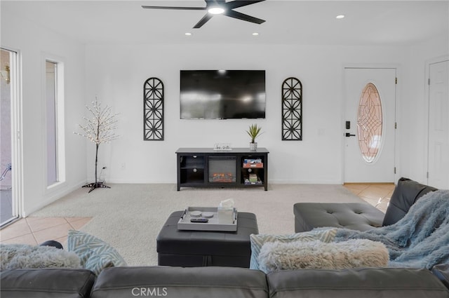 carpeted living room with a healthy amount of sunlight and ceiling fan