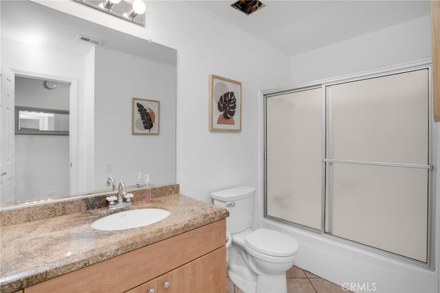 full bathroom with vanity, tile patterned floors, toilet, and combined bath / shower with glass door