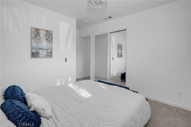 bedroom with light carpet and a closet