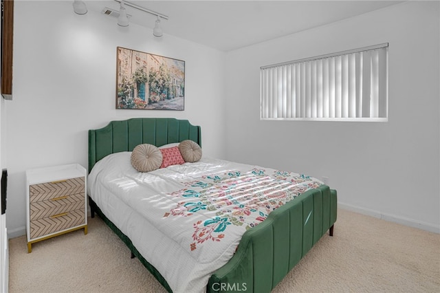 carpeted bedroom with track lighting