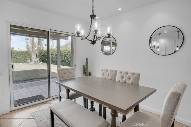 dining space with an inviting chandelier and light tile patterned flooring