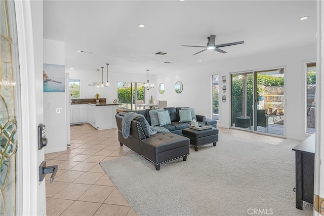 carpeted living room featuring ceiling fan and a healthy amount of sunlight