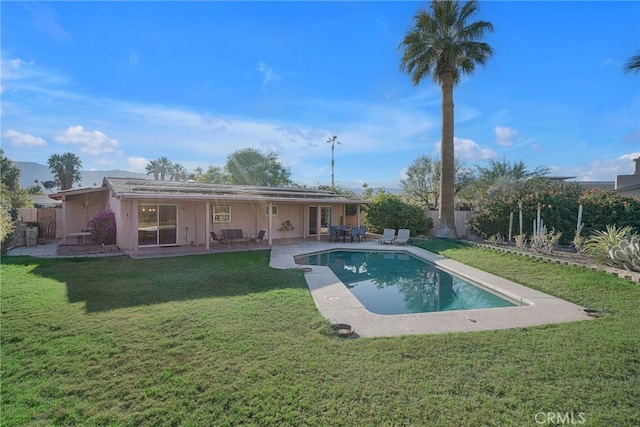 view of swimming pool with a lawn and a patio area