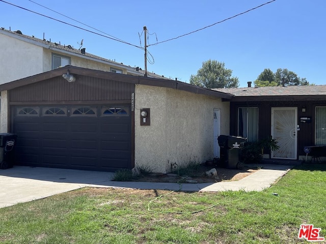 ranch-style home with a garage and a front yard