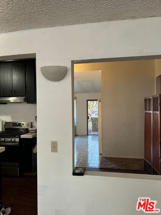 hallway with a textured ceiling