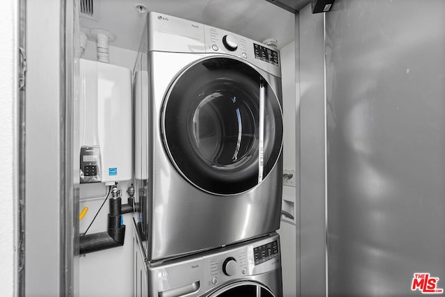 laundry area with stacked washer / drying machine