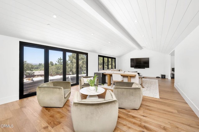 living room with french doors, light wood-type flooring, and lofted ceiling with beams