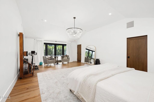 bedroom with lofted ceiling and light hardwood / wood-style floors