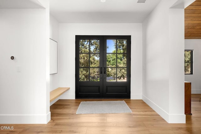 entrance foyer featuring light hardwood / wood-style floors and french doors