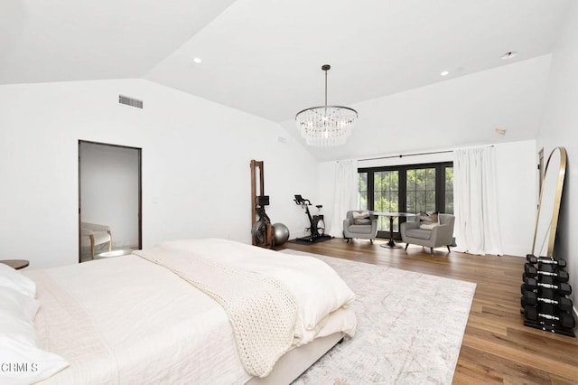 bedroom with vaulted ceiling and hardwood / wood-style flooring