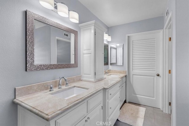 bathroom featuring tile patterned floors and vanity