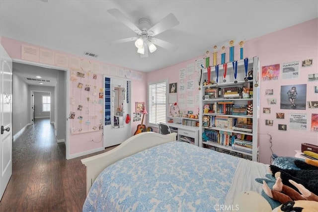 bedroom with ceiling fan and dark hardwood / wood-style flooring