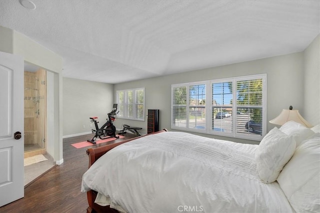 bedroom featuring dark wood-type flooring, connected bathroom, and multiple windows