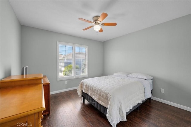 bedroom with ceiling fan and dark hardwood / wood-style flooring