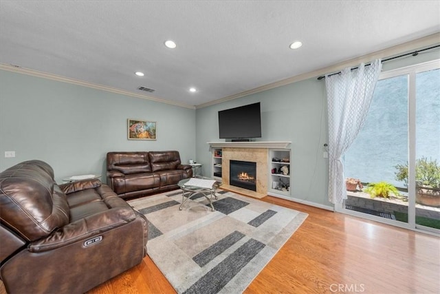 living room featuring crown molding and light hardwood / wood-style floors