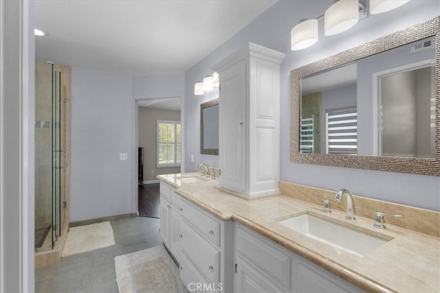 bathroom featuring vanity, tile patterned flooring, and a shower with door